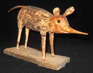 Wood sculpture of a checkered sengi